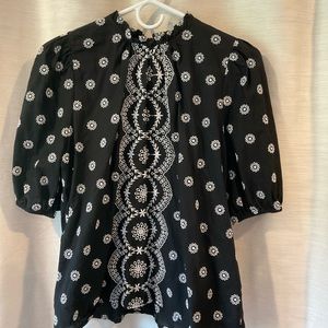 Loft top. Black with with white embroidered design. Short sleeve with elastic.